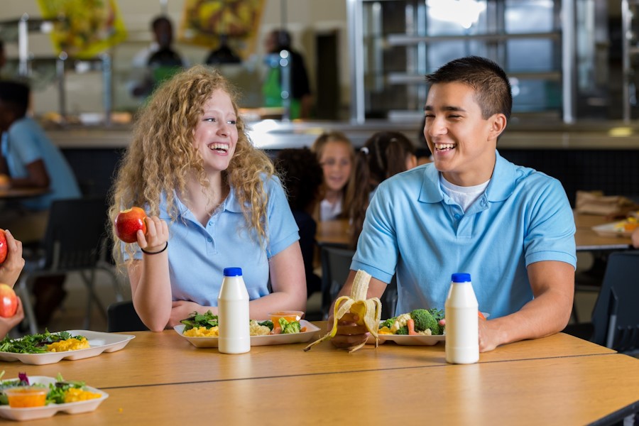 teens having lunch chatting and laughing