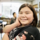 Happy girl in classroom wearing earphones