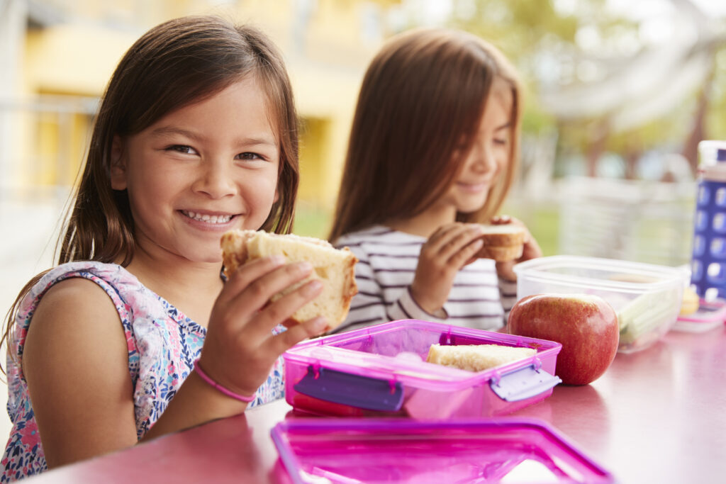 schoolgirl eating a sandwich